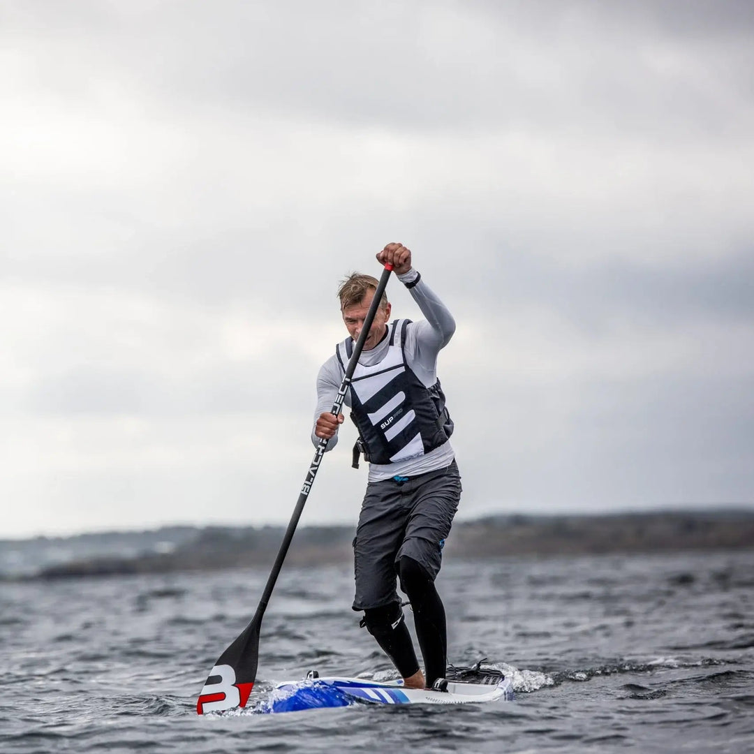 Baltic SUP Pro Buoyancy Aid In White and Navy On A Male Paddleboarder