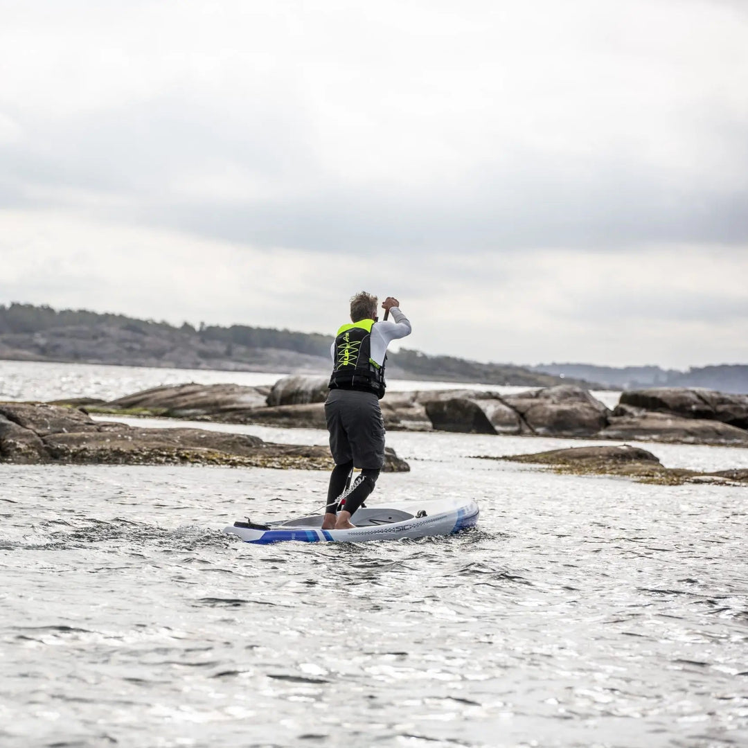 Baltic SUP Elite Buoyancy Aid UV Yellow On Male Paddleboarder
