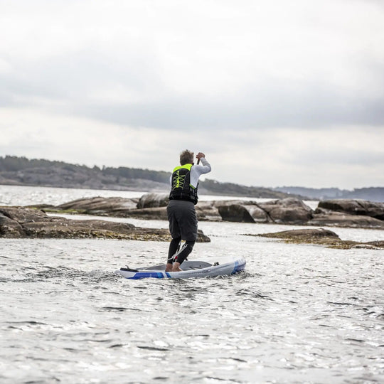 Baltic SUP Elite Buoyancy Aid UV Yellow On Male Paddleboarder