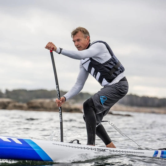 Baltic SUP Pro Buoyancy Aid in White and Navy Worn On The Water