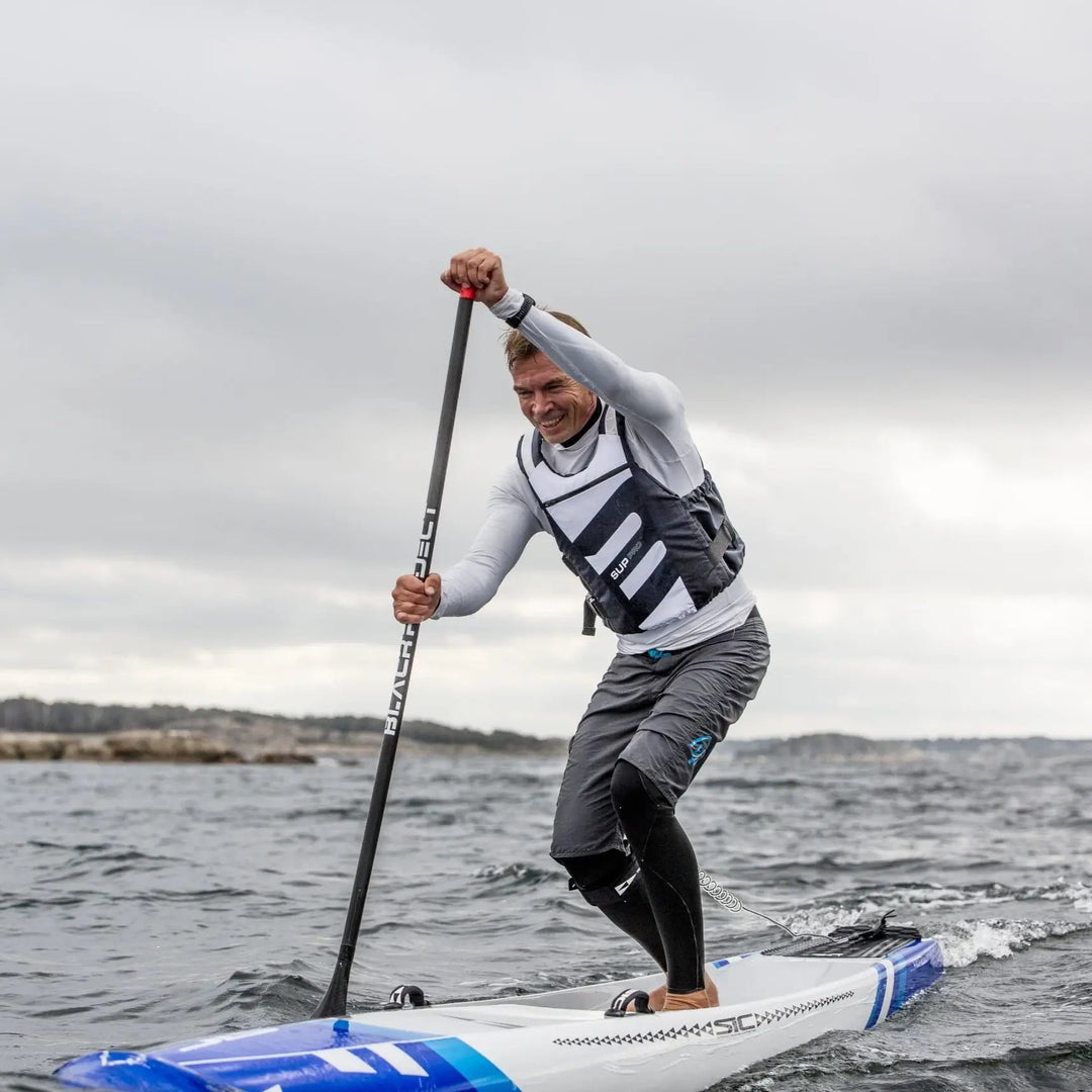 Baltic SUP Pro Buoyancy Aid In White Action Shot of Male Paddleboarder