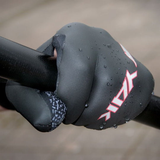 Paddler wearing black 3mm neoprene open palm mitts for SUP and kayaking while holding a paddle.