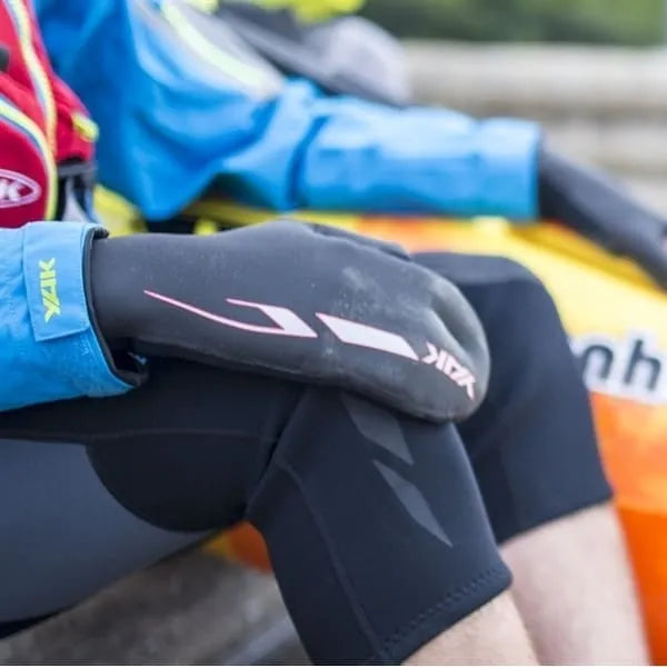 Paddler wearing black 3mm neoprene open palm mitts for SUP and kayaking.