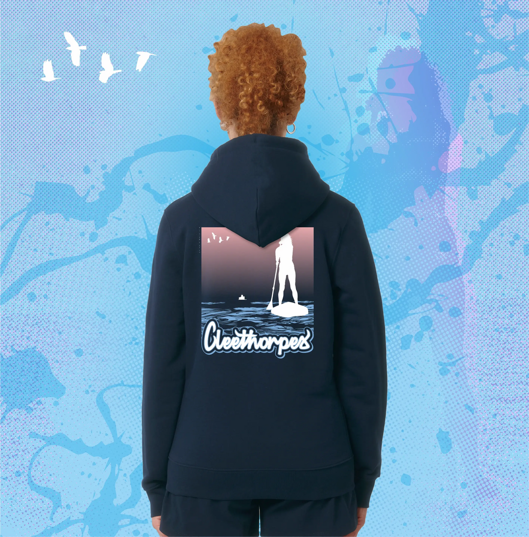 Person wearing a navy Cleethorpes hoodie with a Paddleboarding graphic design on the back against a blue abstract background.