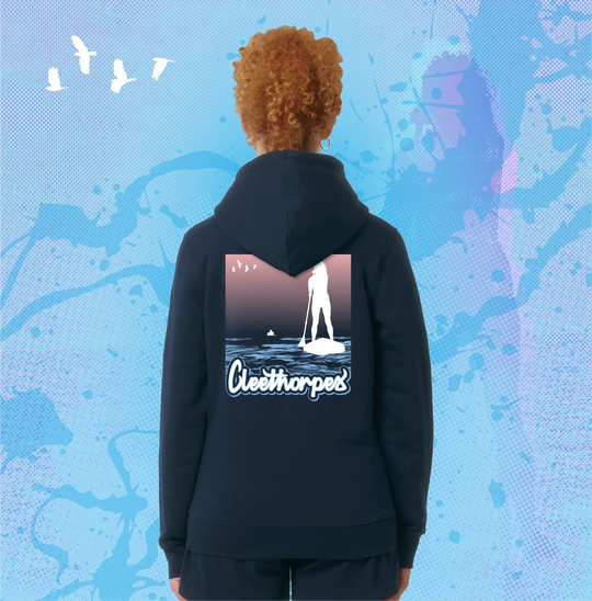 Person wearing a navy Cleethorpes hoodie with a Paddleboarding graphic design on the back against a blue abstract background.