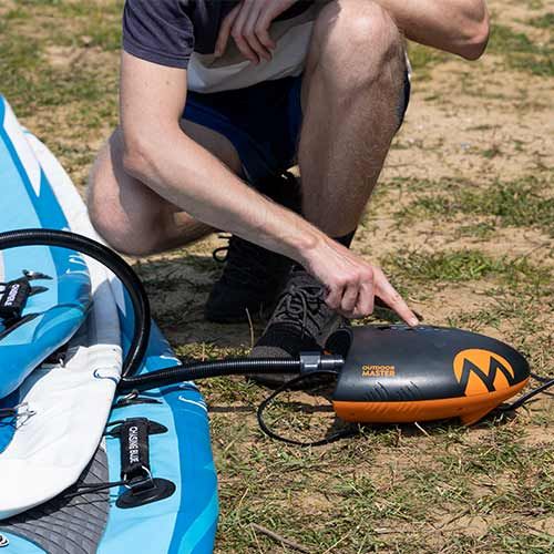 Person inflating paddleboards using the Outdoor Master Shark 2 pump./