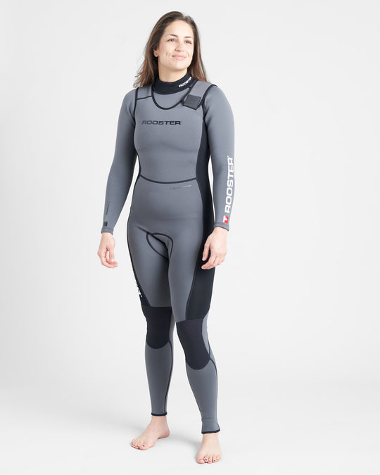 A person standing and smiling, wearing a gray long-sleeved wetsuit with black accents and the brand name 'ROOSTER' visible on the upper left thigh.