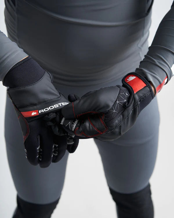 Model wearing black and red sailing gloves including mitten covering with a visible brand logo on a white background.