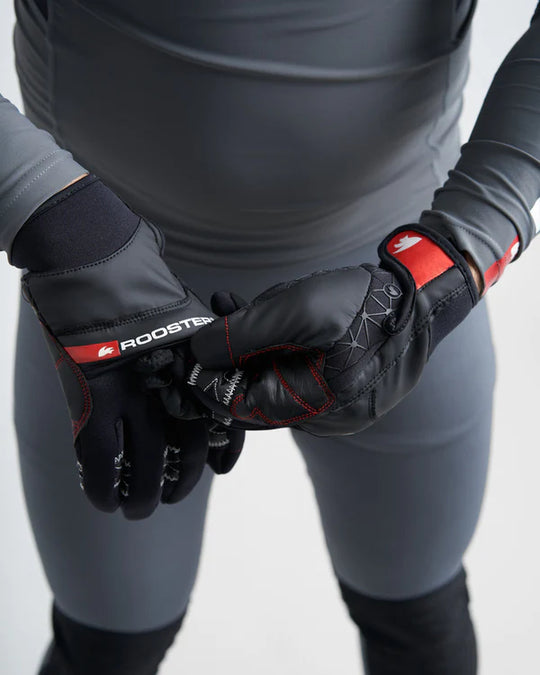 Model wearing black and red sailing gloves including mitten covering with a visible brand logo on a white background.