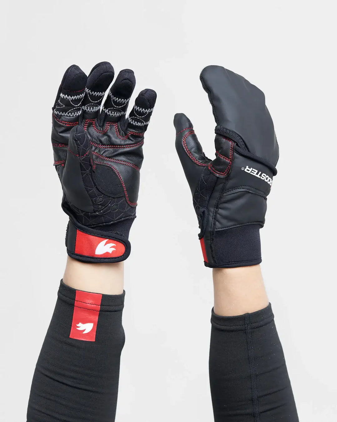 Black and red sailing gloves including mitten covering with a visible brand logo on a white background.