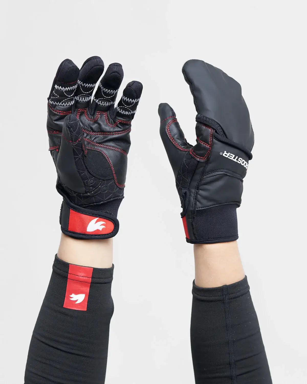 Black and red sailing gloves including mitten covering with a visible brand logo on a white background.