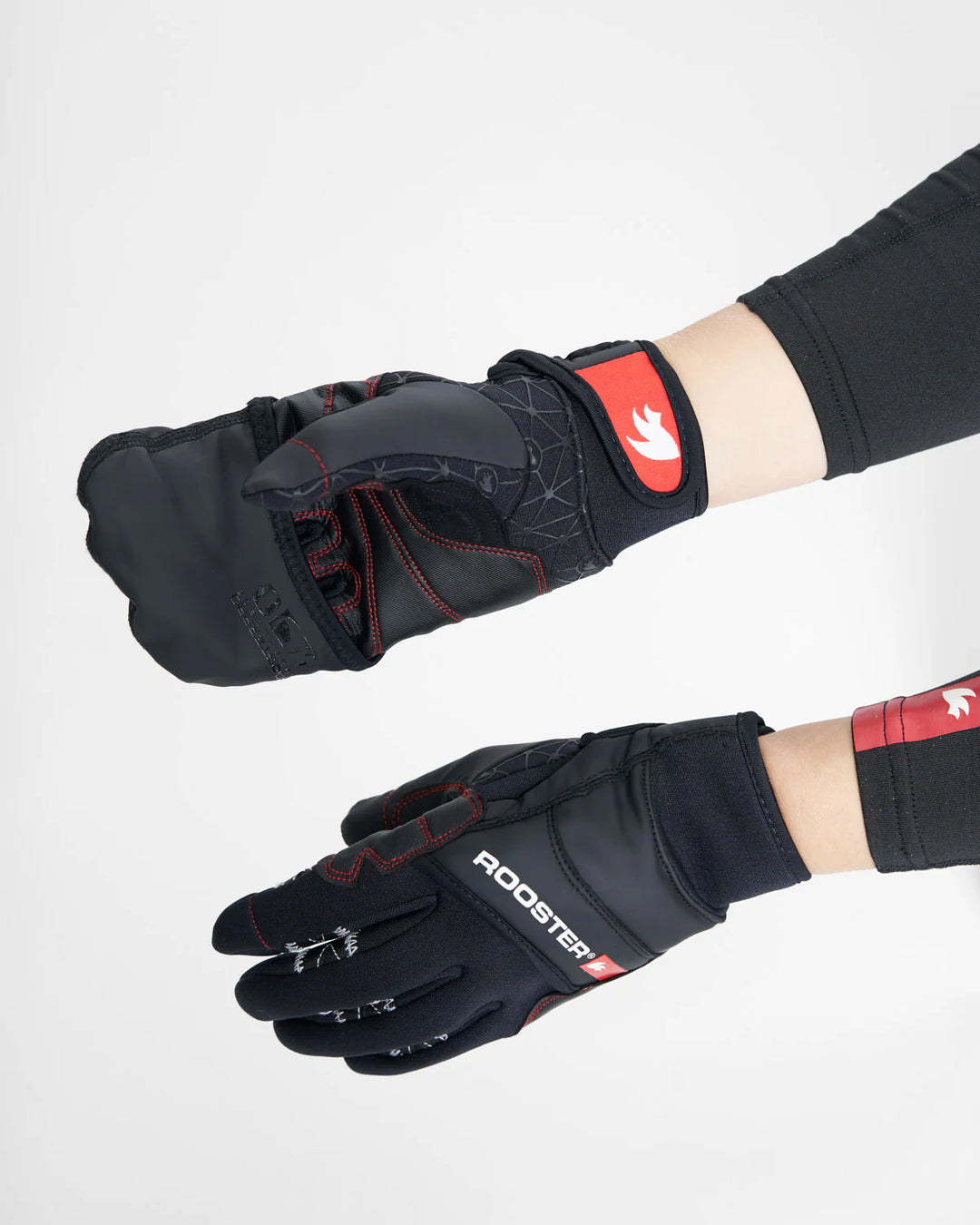 Black and red sailing gloves including mitten covering with a visible brand logo on a white background.