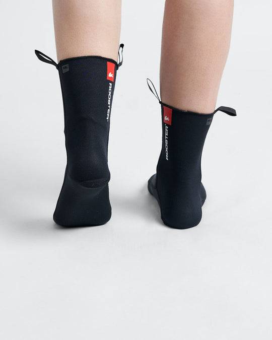 Back view of black neoprene socks with a red and white rooster logo, designed for water activities.