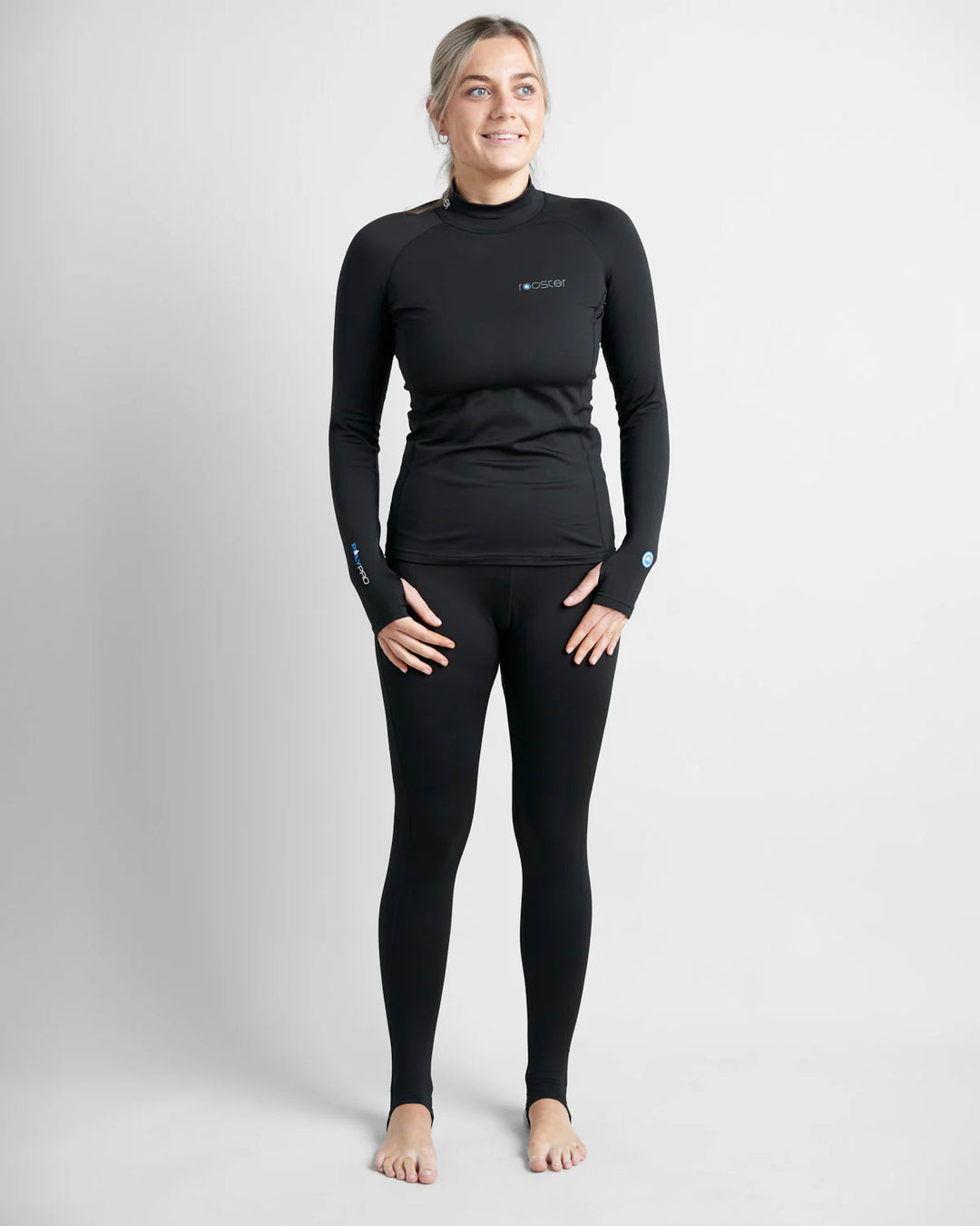 Person wearing a black base layer long-sleeve top and leggings on a light grey background