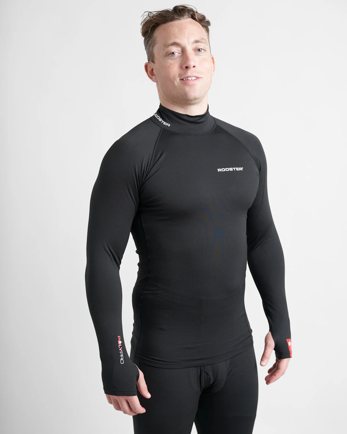 Man wearing a black long-sleeve hydrophobic base layer top with a visible brand logo on a light white background.