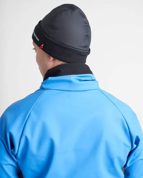 Person wearing a black sailing hat and blue jacket on a white background.