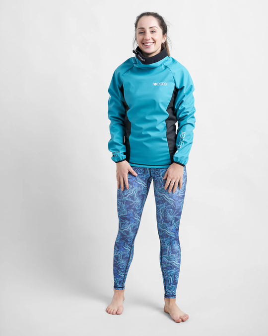 Person wearing a teal aquafleece top and patterned leggings on a white background.