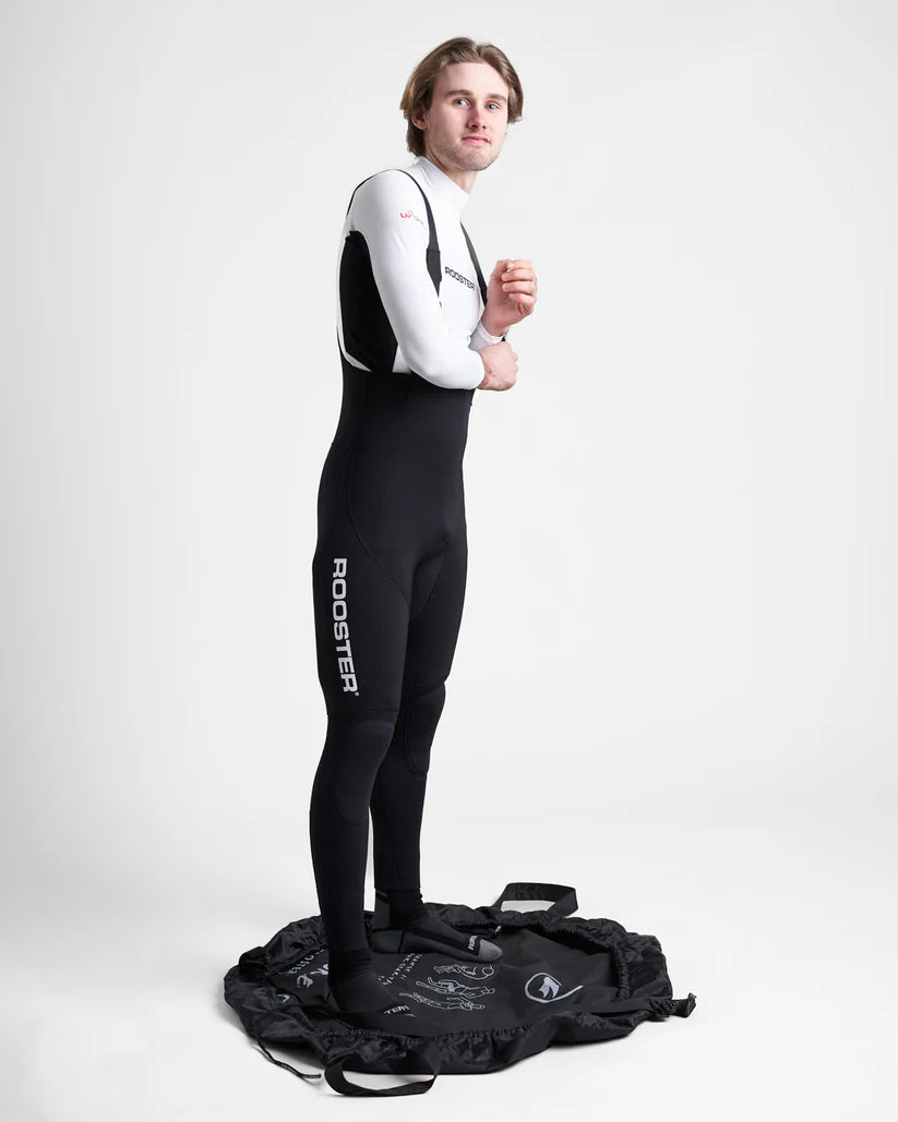 Studio image of the Rooster Changing Mat Bag showing a model stood in the open mat bag on a white background.