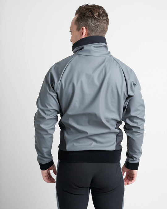 Man wearing a grey Aquafleece sailing spray top over a black wetsuit on a white background.