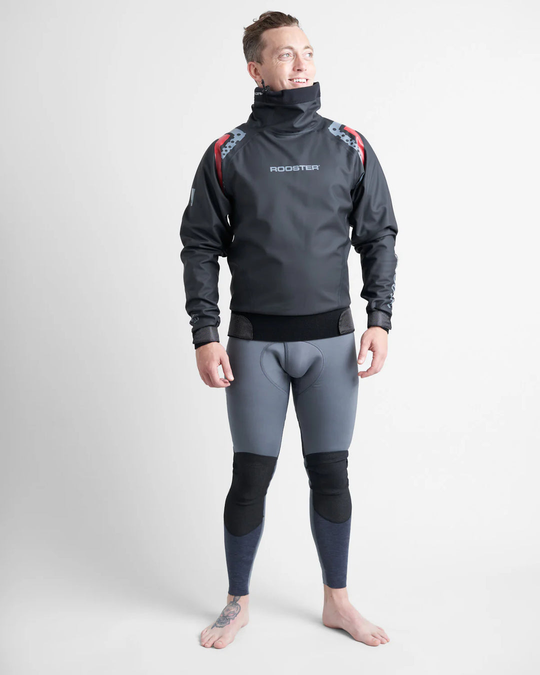 Person wearing a black Rooster Pro Aquafeece spray top over a grey wetsuit with 'Rooster' branding on a white background.