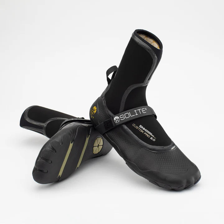 A pair of black neoprene watersport boots with the Solite brand logo on the strap.