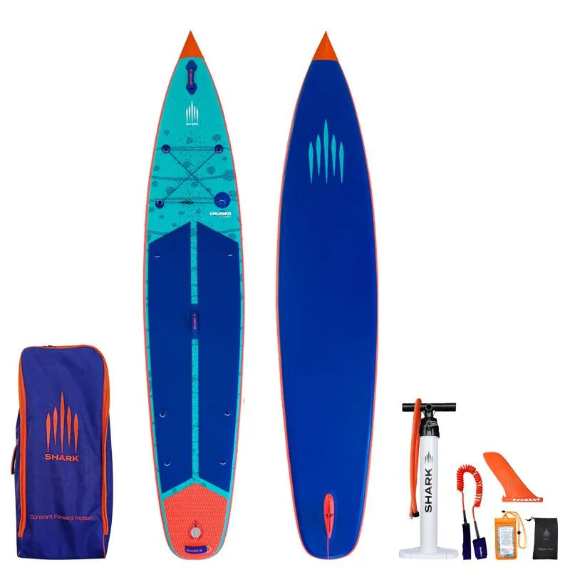 Image of Shark SUPS Cruiser Flow 11'6 x 28" x 5" inflatable paddle board with light blue deck featuring shark skin graphics and a dark blue bottom. Also showing package accessories.