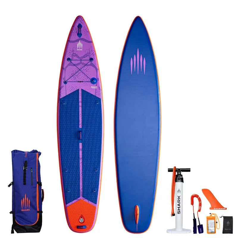 Image of Shark SUPS Roam 11'6 x 30" x 5" inflatable travel paddle board with light purple deck featuring shark skin graphics and a dark blue bottom. Also showing package accessories.
