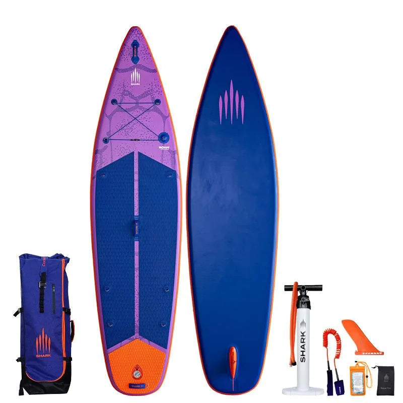 Image of Shark SUPS Roam 11'6 x 34" x 5" inflatable travel paddle board with light purple deck featuring shark skin graphics and a dark blue bottom. Also showing package accessories.