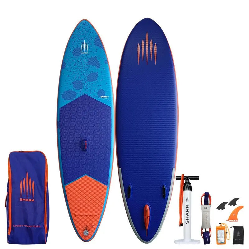 Image of Shark SUPS Surf 9'2 x 32" x 5" inflatable surf paddle board with light blue deck featuring shark skin graphics and a dark blue bottom. Also showing package accessories.