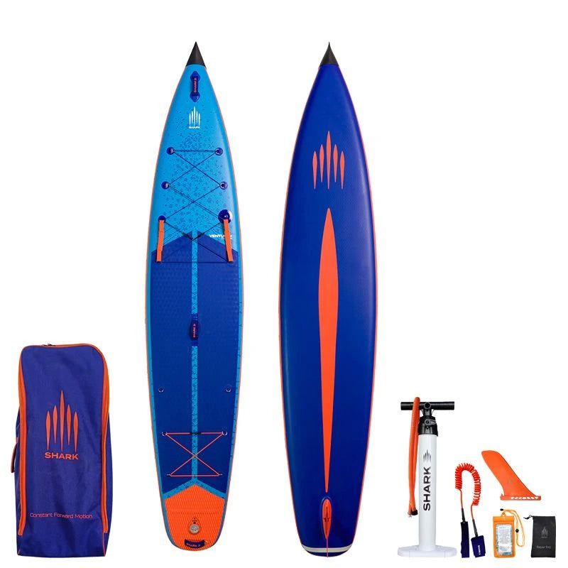 Image of Shark SUPS Venture Plus 12'6" x 28" x 5" inflatable touring paddle board with light blue deck featuring shark skin graphics and a dark blue bottom. Also showing package accessories.