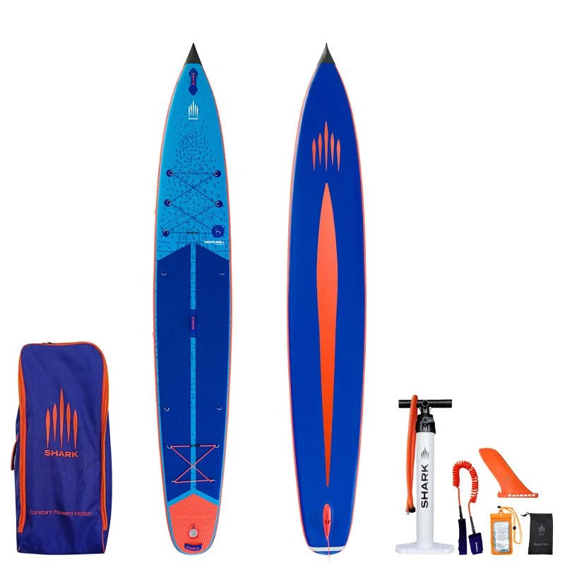 Image of Shark SUPS Venture Plus 14'0" x 28" x 5" inflatable touring paddle board with light blue deck featuring shark skin graphics and a dark blue bottom. Also showing package accessories.