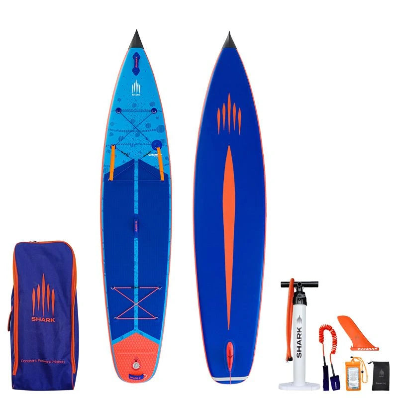 Image of Shark SUPS Cruiser Plus 11'6 x 30" x 5" inflatable paddle board with light blue deck featuring shark skin graphics and a dark blue bottom. Also showing package accessories.