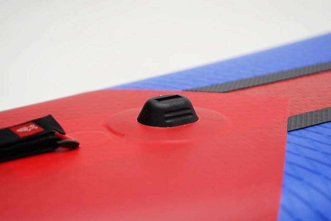 Close-up of a red and blue Starboard All Star Airline Inflatable Paddleboard with a black FCS insert mount with a white background