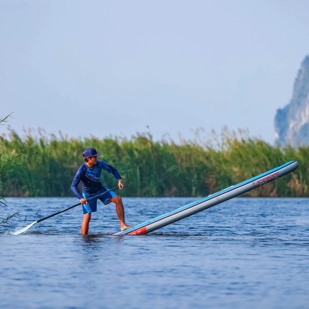 Action Shot with a Paddleboarder doing a step back turn on a Starboard Touring M 14'0 x 30 SUP.