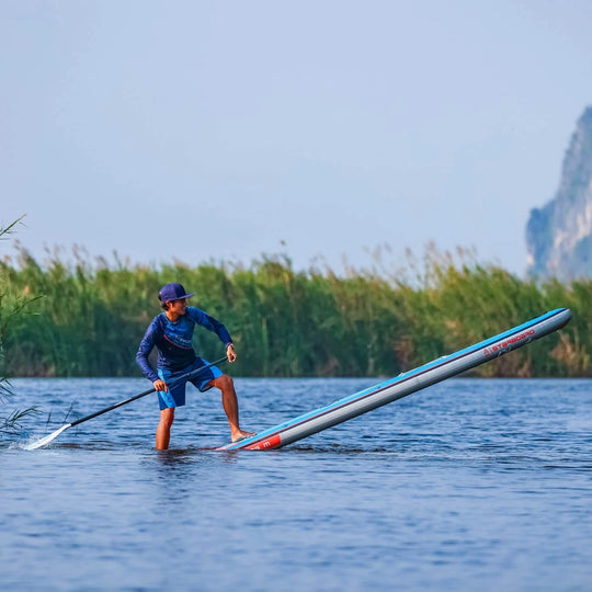 Action Shot with a Paddleboarder doing a step back turn on a Starboard Touring M 14'0 x 30 SUP.