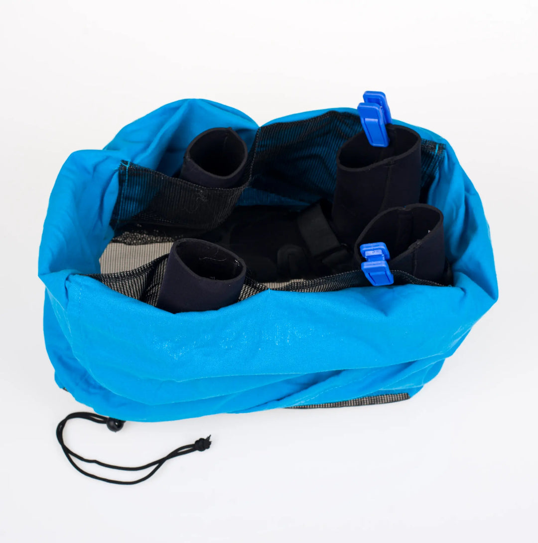 Blue Surflogic Wetsuit Pro Dryer Accessories Bag with black boots inside on a white background.