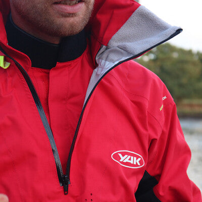 Male wearing a Yak Apollo dry top in red focusing on the neck seal.